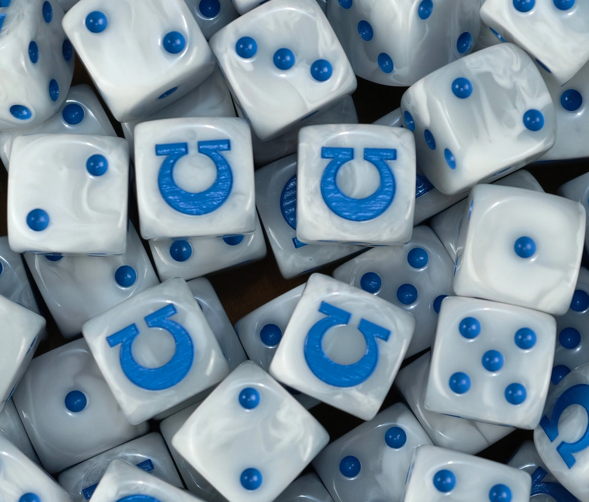 A pile of white Ultramarines D6 with blue pips and blue omegas