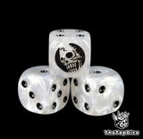 Close up of a white 16mm resin D6 die engraved with a black skeleton emblem and black pips