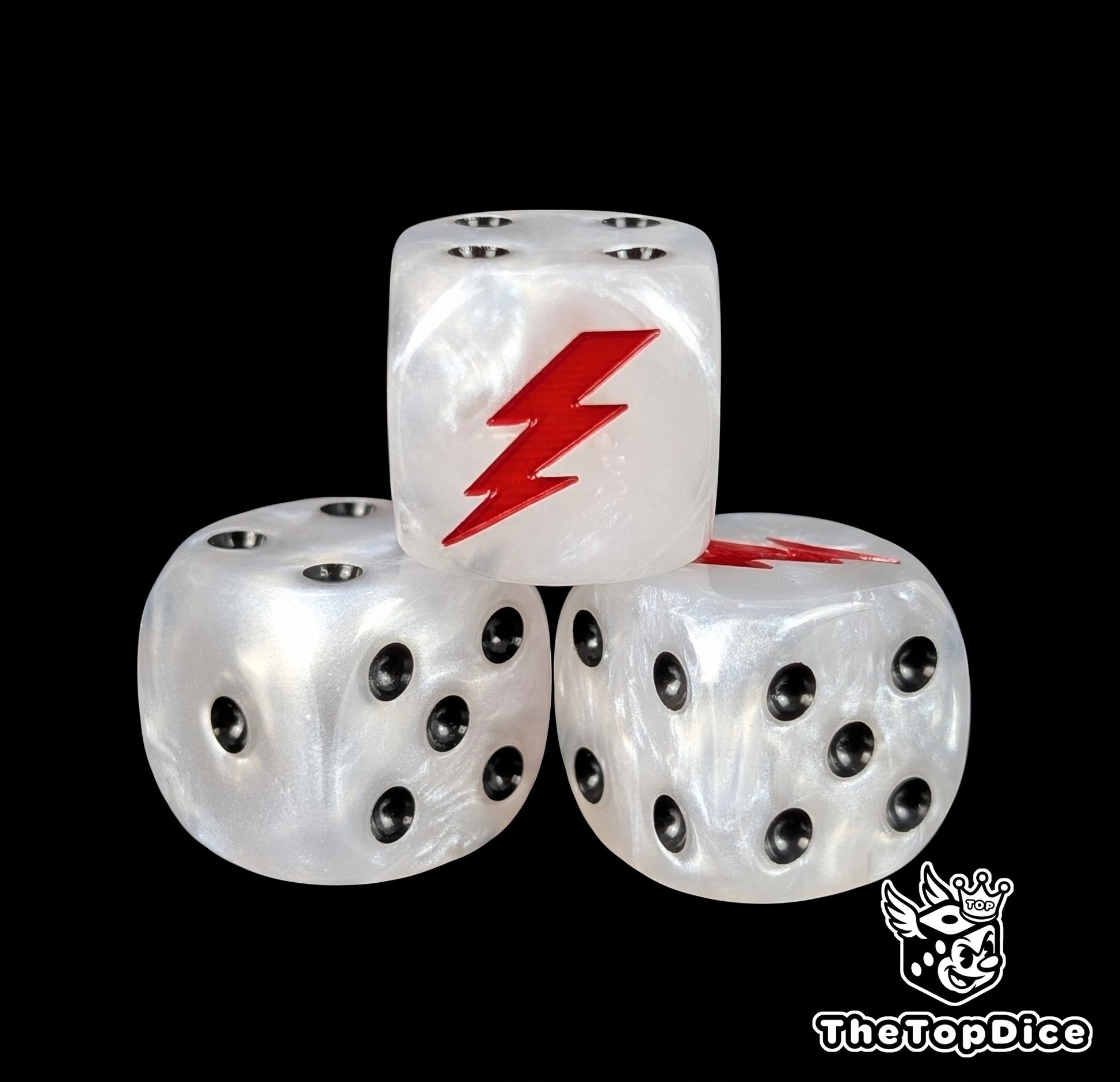 Close up of a white 16mm resin D6 die engraved with a red lightning bolt and black pips