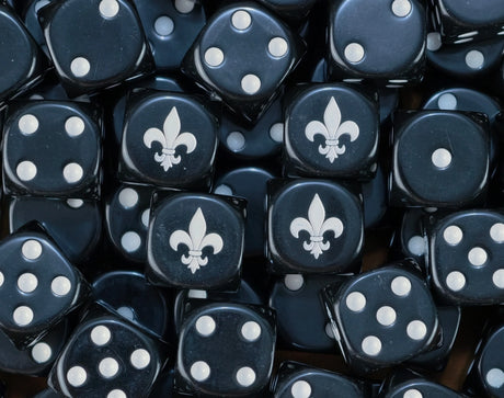 A pile of black Adepta Sororitas dice with white pips and fleur de lis