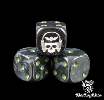 Close up of a black and grey 16mm resin D6 die engraved with a white winged skull in a helmet and green pips