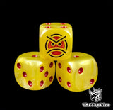 Close up of a yellow 16mm resin D6 die engraved with a red angry face and red pips